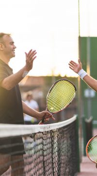 Father,And,Son,Playing,Tennis,One,To,One.,Family,Doing