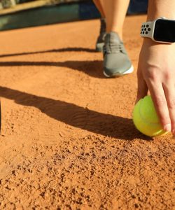 Woman,Wearing,Modern,Smart,Watch,During,Training,On,Tennis,Court,
