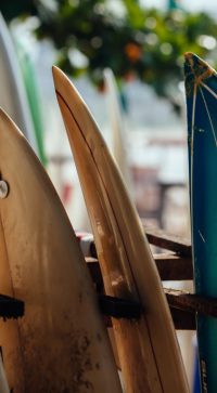 Set,Of,Different,Color,Surf,Boards,In,A,Stack,By