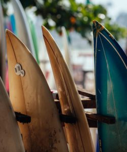 Set,Of,Different,Color,Surf,Boards,In,A,Stack,By